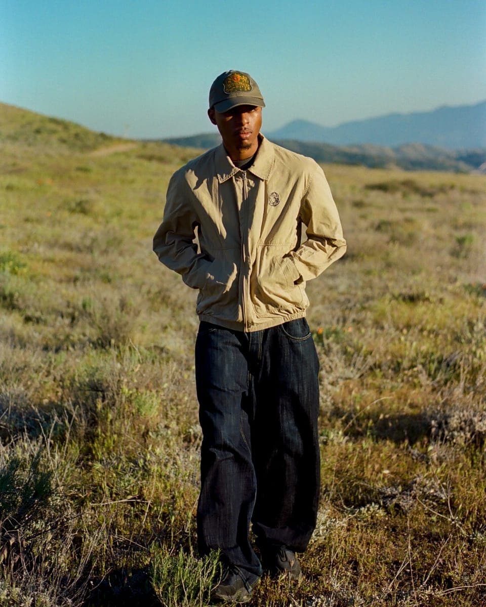 A Billionaire Boys Club jacket and cap worn in open hill country